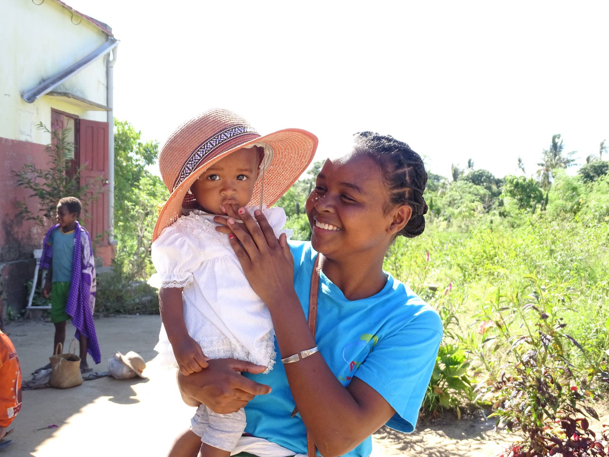 A Malagasy mother smiles while holding her child in southeast Madagascar