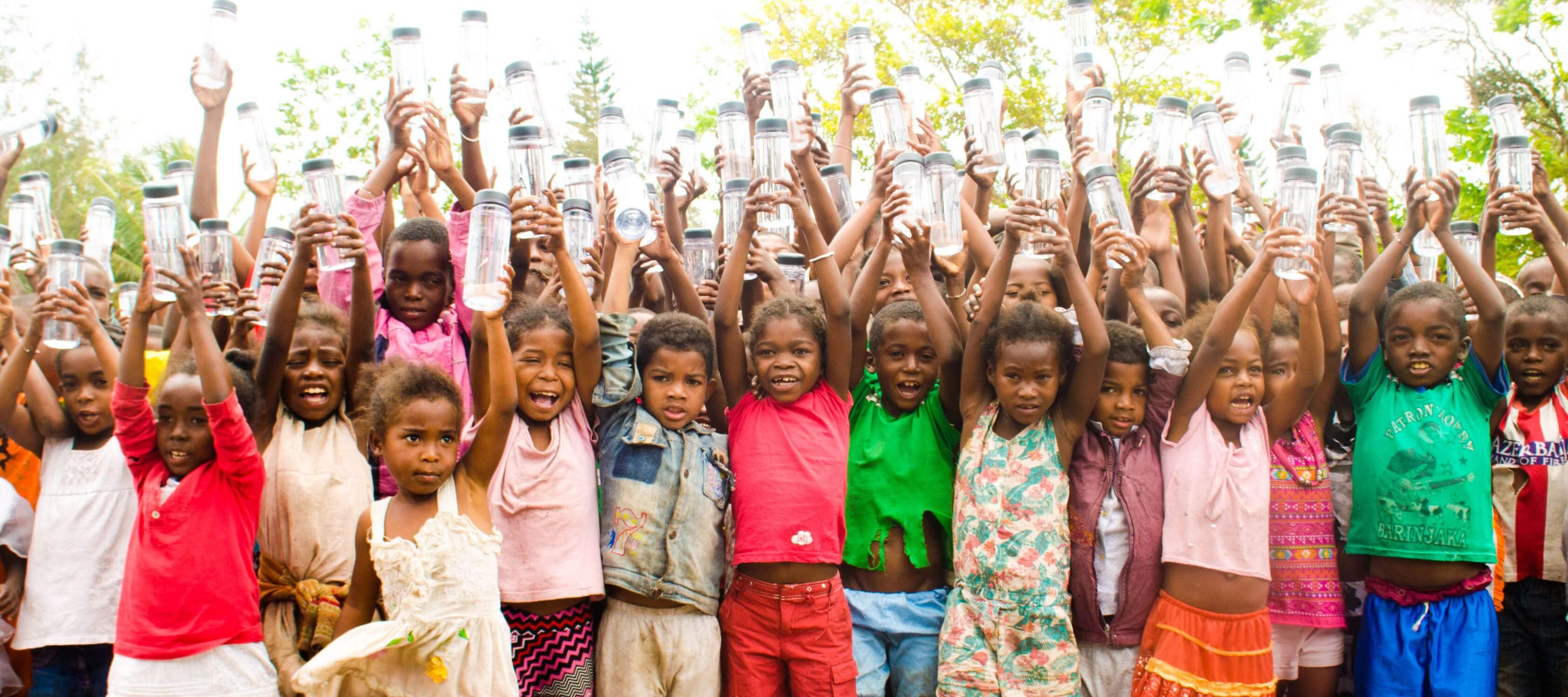 Children receive water bottles at the Tatirano opening ceremony