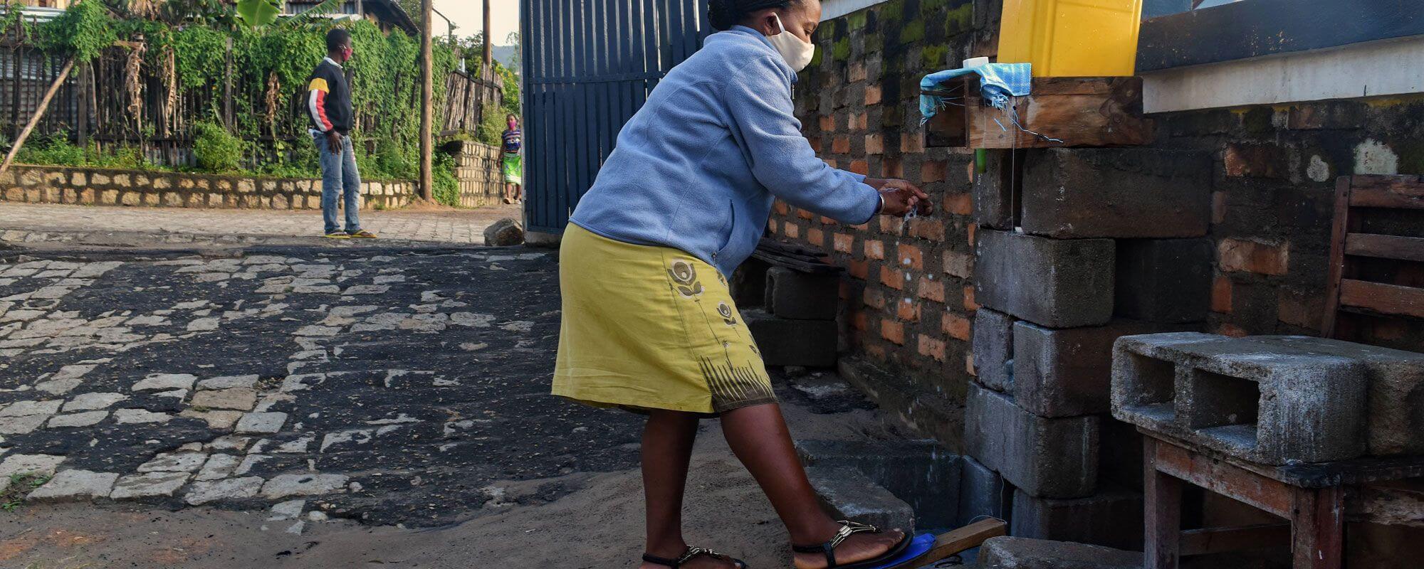 Using the contactless handwashing station at the entrance to the SEED Madagascar office in Taolagnaro