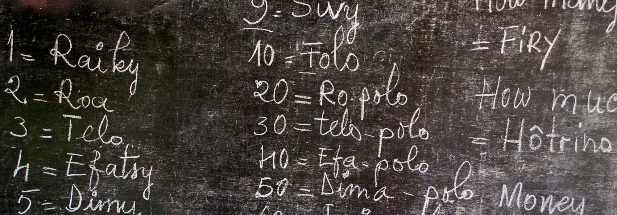 A chalkboard with Malagasy language lesson