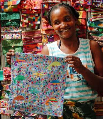 stitch-sainte-luce-embroiderer-cleire-holding-up-cushion-cover.jpg