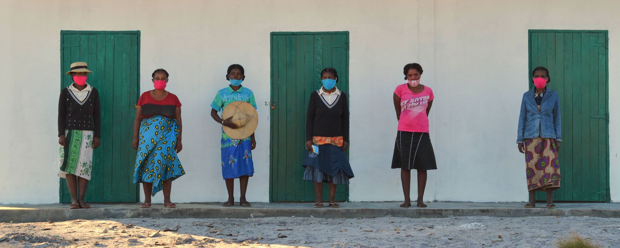 Leaders of the mahampy weavers cooperative standing outside the newly completed studio