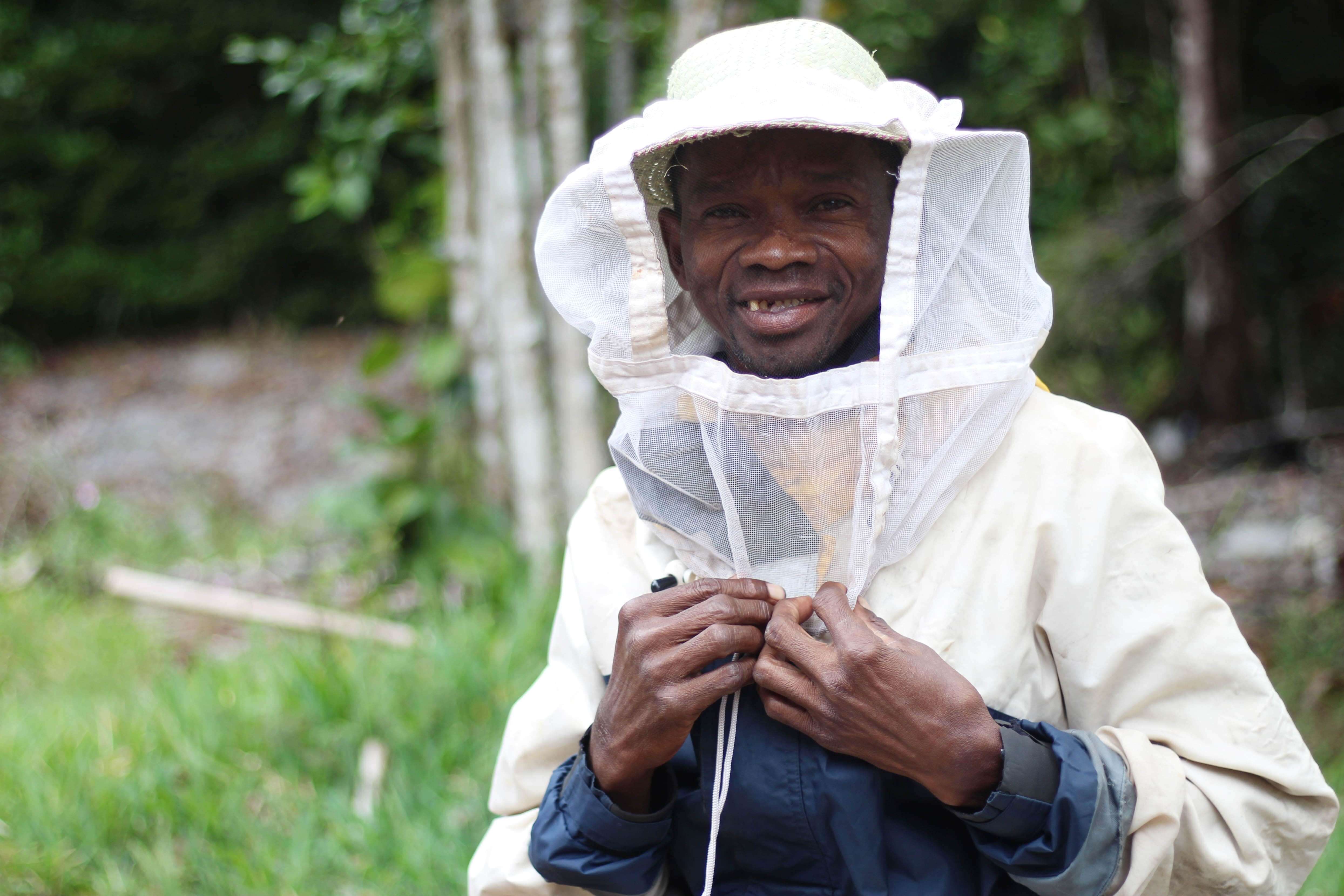 Renitantely beekeeper in protective suit