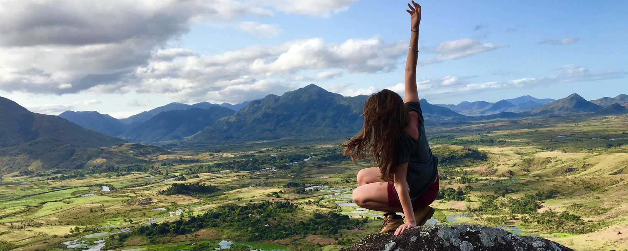 A SEED staff member climbs a mountain