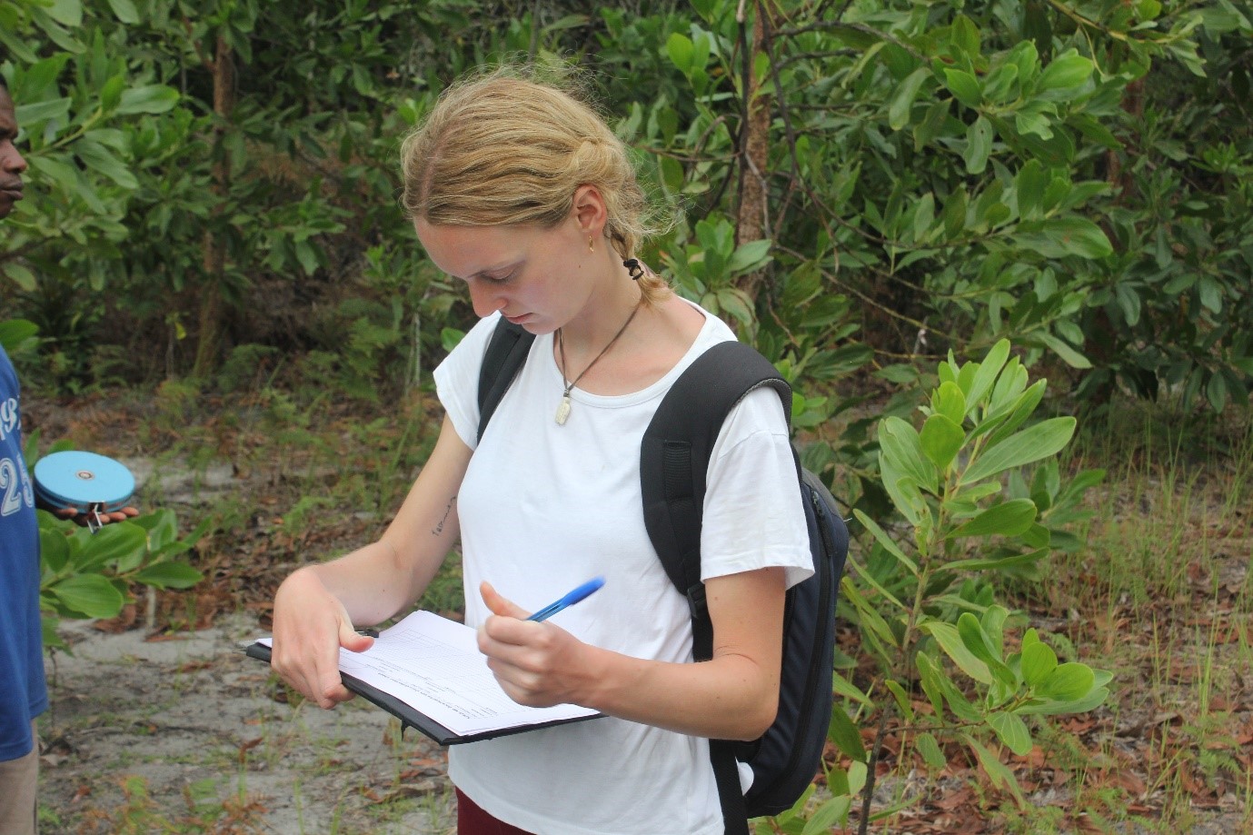 Bella taking notes to monitor the tree growth for a Project Ala forest corridor