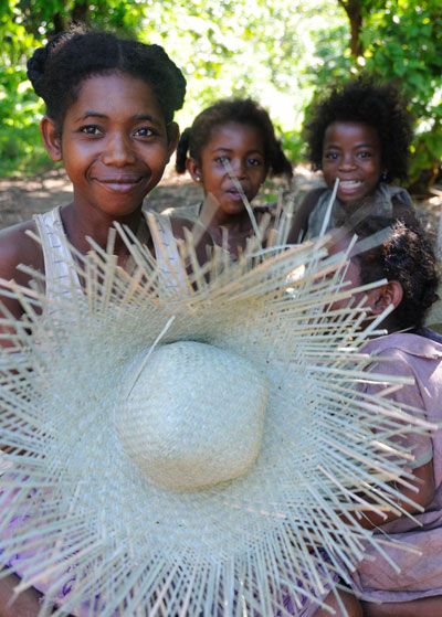  A young weaver holds up a mahampy hat