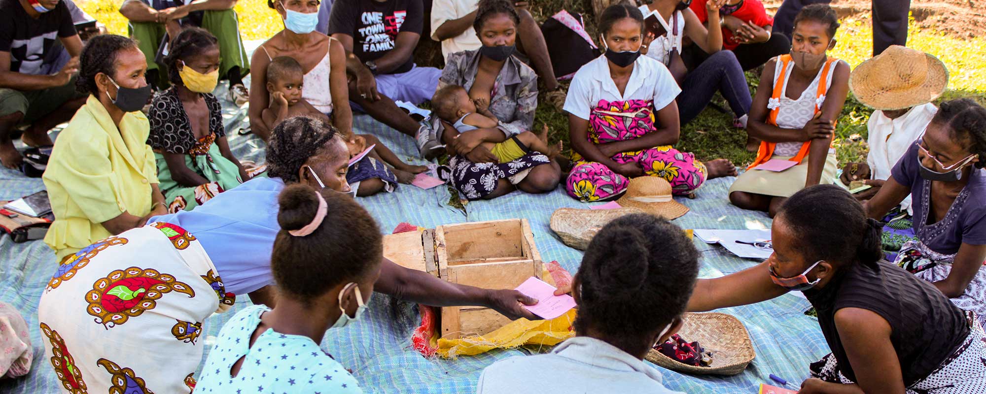 Women sit at as community meeting held in rural Madagascar to discuss setting up a savings and loan association