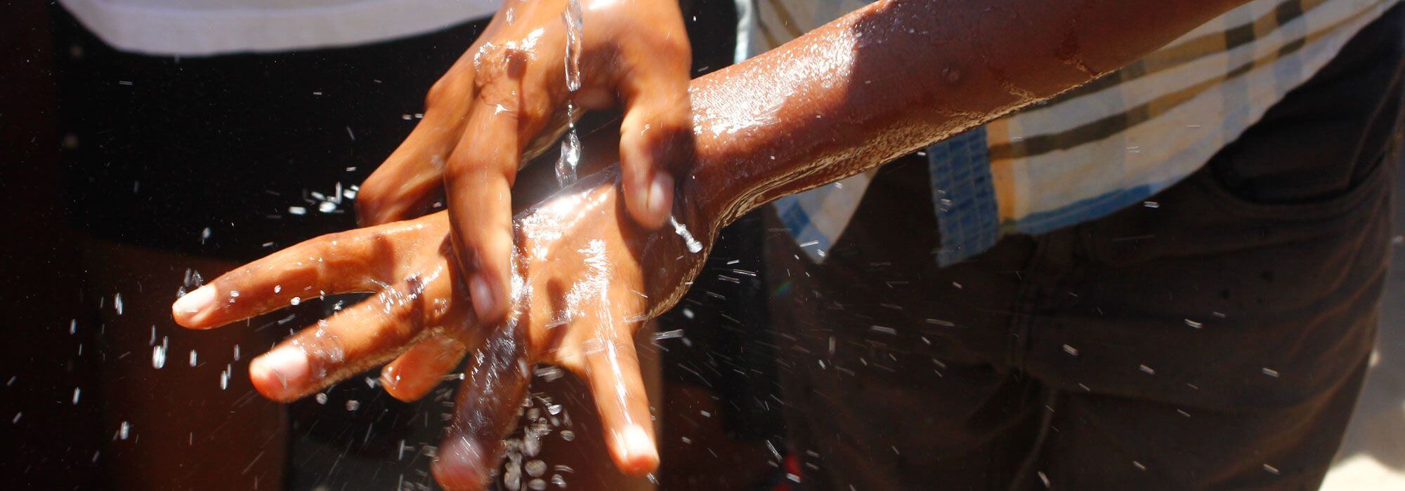 A child washing his hands with soap and water