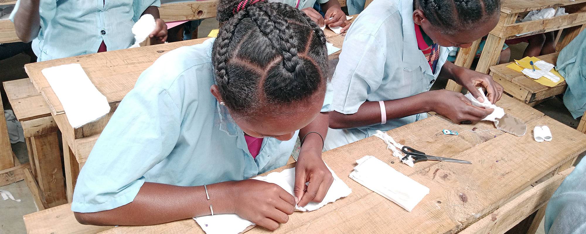 Students sewing reusable menstrual hygiene management pads at a SEED school in Madagascar