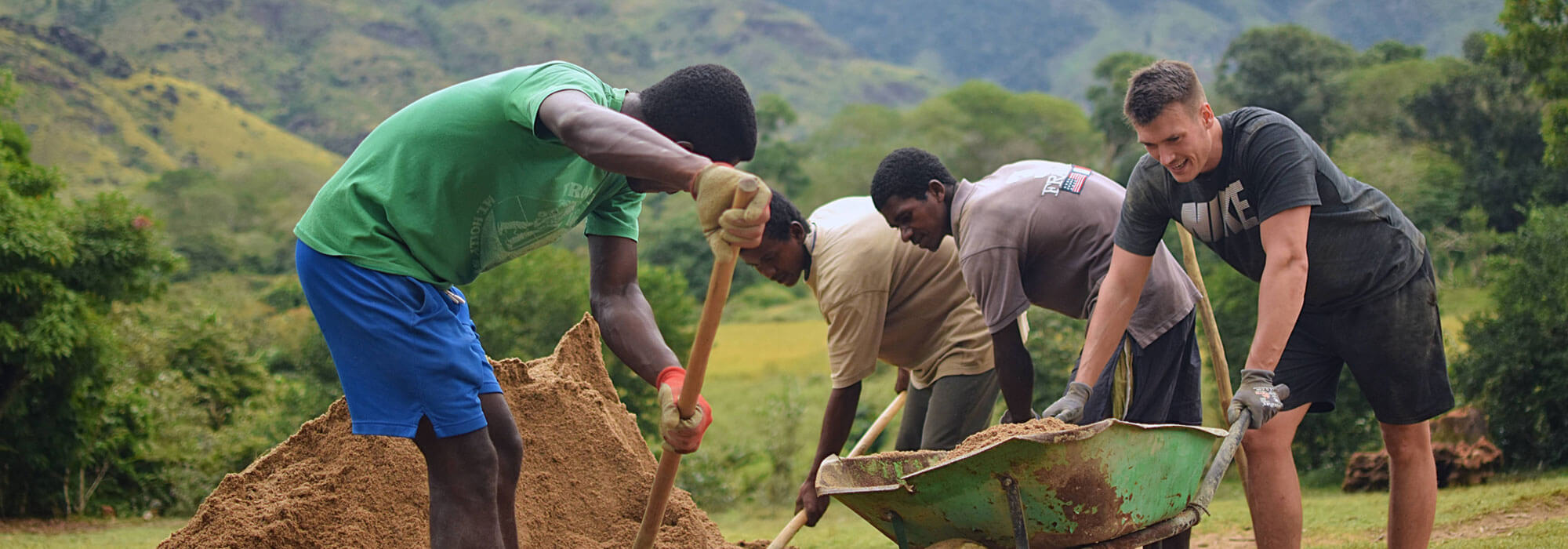 A corporate social responsibility volunteer working with local staff on the construction site