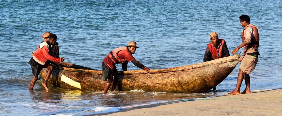 Pirogue canoe landing on a beach in Sainte Luce Madagascar