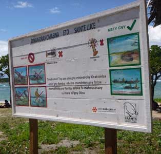  Signboard illustrating key points of the local dina regulations in Sainte Luce, Madagascar