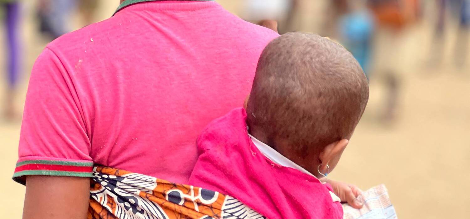 A Malagasy mother with a child on her back in southeast Madagascar