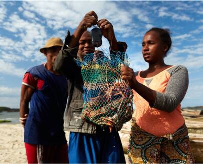 Traders weighing a bag of lobsters